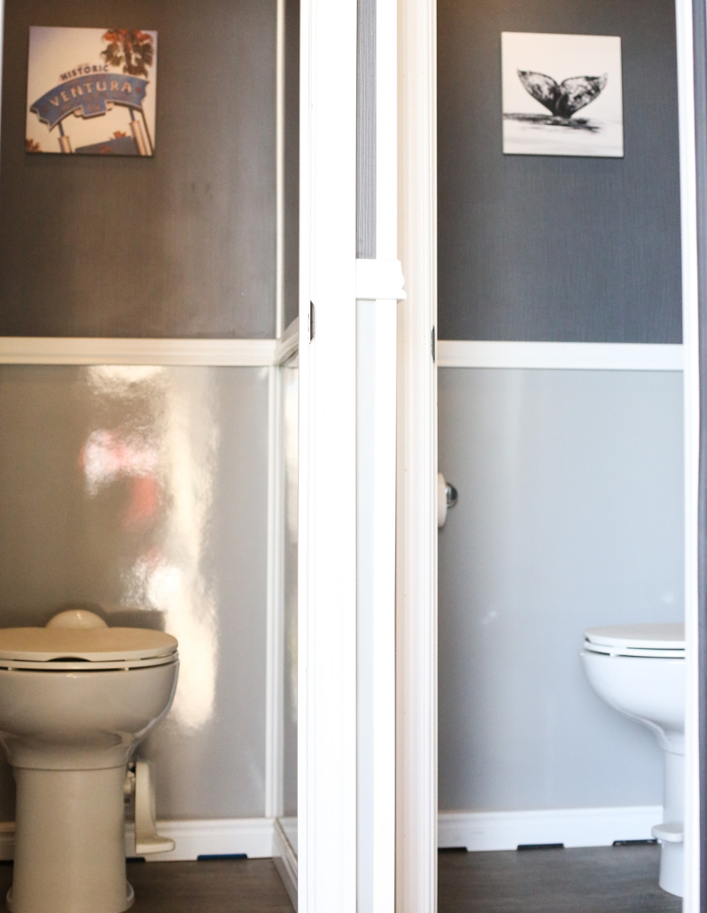 An inside look of the female side of the JW Premier Restroom trailer showing two toilets.
