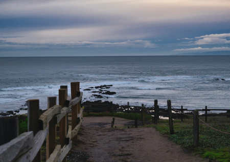 Wooden fence along the coastal bluffs in Half Moon Bay, California