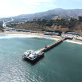 Aerial view of the Malibu Pier and coastline along Pacific Coast Highway