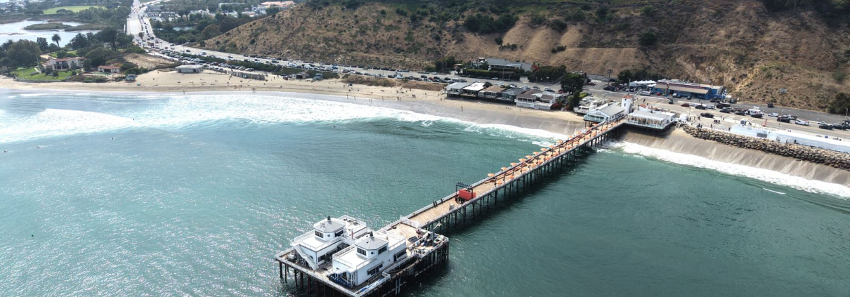 Aerial view of the Malibu Pier and coastline along Pacific Coast Highway