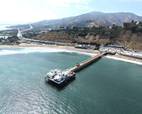 Aerial view of the Malibu Pier and coastline along Pacific Coast Highway